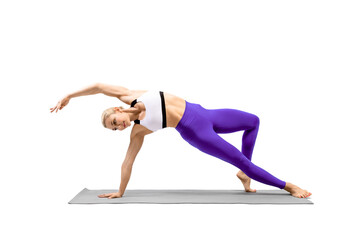Balance and stretching yoga. Attractive fit woman in sportswear practice Camatkarasana exercise,...