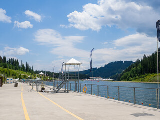 Sights of the modern popular ski resort of Bukovel. Empty Lake of Youth beach in Bukovel in summer. It is the largest ski resort in Eastern Europe situated in West of Ukraine. 