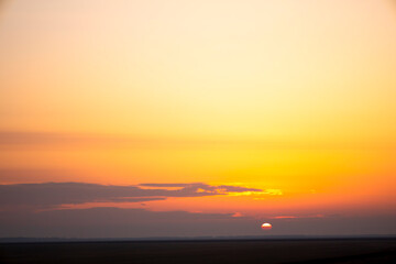 The sky in the evening has some parts of orange, reflecting light from the sun.