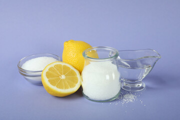 Concept of cleaning products, lemon acid on violet background