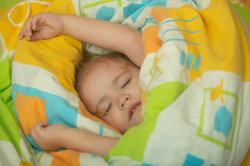 Baby lying in bed and sleeping. Child sleep quietly calmly on bed at home. Adorable cute toddler or baby sweet dreaming in bedroom. Lovely child get deep sleep and get relax.