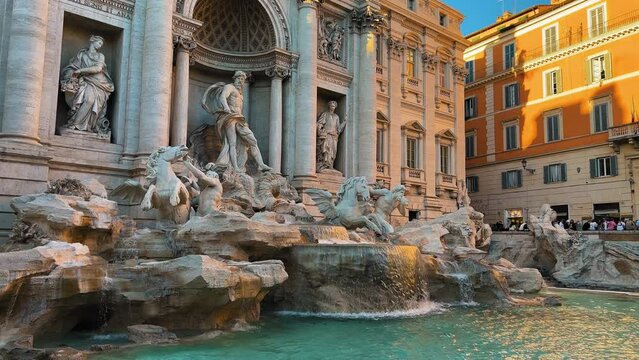 Slow motion shot of splashing water with famous old figures in Rome during sunset -