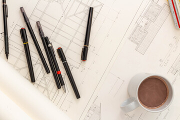 Mockup of architectural concept, Drawing tools and hot coffee on engineer drawing of blueprint