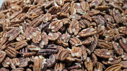 Raw English walnut nuts for sale at local city market. Pile of peeled English walnut. Natural background