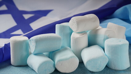 Israel national flag and marshmallows. Concept of Independence day Israel - Yom Ha`atzmaut.
