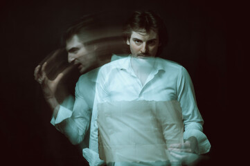 schizophrenic blurred portrait of psychopathic man with mental disorders and disorders on dark background