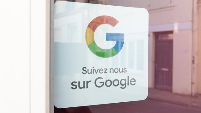 Google sign logo and brand text front of windows store door on sticker customer review