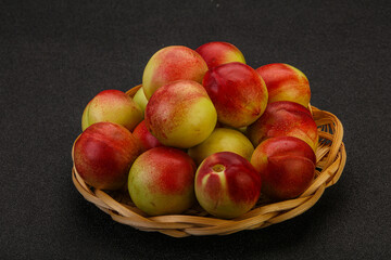 Sweet small nectarines in the basket