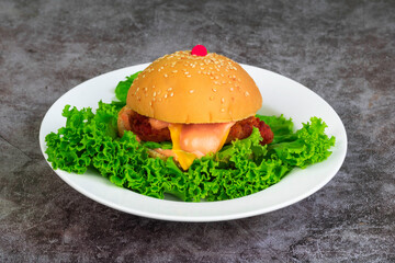 Chicken hamburger and lettuce in plate.