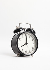 black vintage style alarm clock isolated on a white background