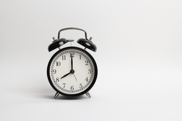 black vintage style alarm clock isolated on a white background