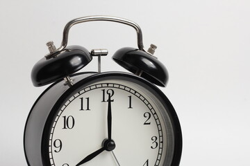 black vintage style alarm clock isolated on a white background