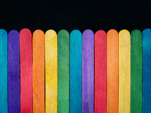 Wooden multicolored sticks background. Stock photo.