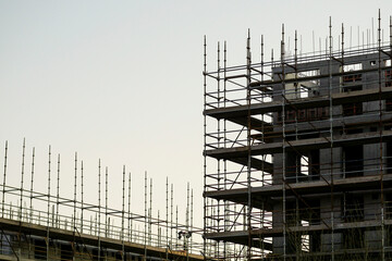 Construction site of a new building in scaffolding. Nobody. Developing industry and technology