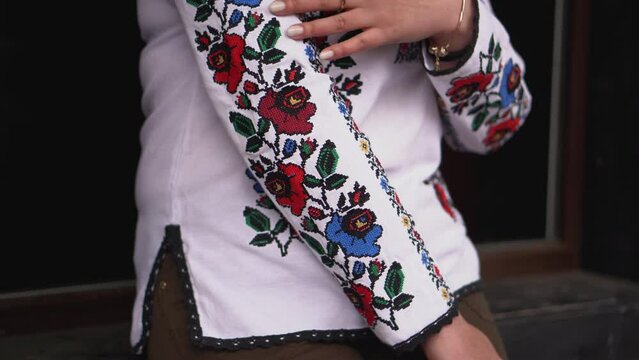 Ukrainian national clothes. Ukrainian brunette in an embroidered shirt walks in the park.