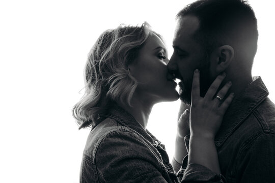 couple kissing on black, silhouette of a couple, portrait of a couple.  close portrait of a couple in love. portrait man woman on white background.