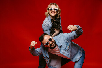 couple in love posing fun with french dog, happy couple portrait with dog.