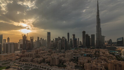 Fototapeta na wymiar Sunset over Dubai Downtown timelapse with tallest skyscraper and other towers