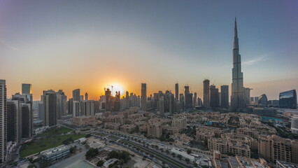 Fototapeta na wymiar Dubai Downtown day to night transition timelapse with tallest skyscraper and other towers