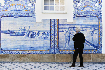 typical blue azulejos tiles on the facade of the old railways station which tells a story of life...