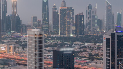 Rows of skyscrapers in financial district of Dubai aerial day to night timelapse.