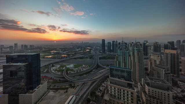 Sunrise over Dubai marina and JLT skyscrapers along Sheikh Zayed Road aerial timelapse. © neiezhmakov