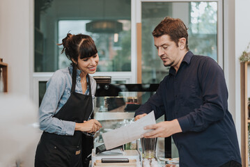 Caucasian woman barista take order from customer in coffee shop. female barista using digital tablet to take order. Coffee owner concept.