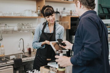 Caucasian woman barista take order from customer in coffee shop. female barista using digital tablet to take order. Coffee owner concept.