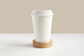 Front view of a White coffee paper cup. Mockup with lid. Paper cups for coffee or tea on beige...