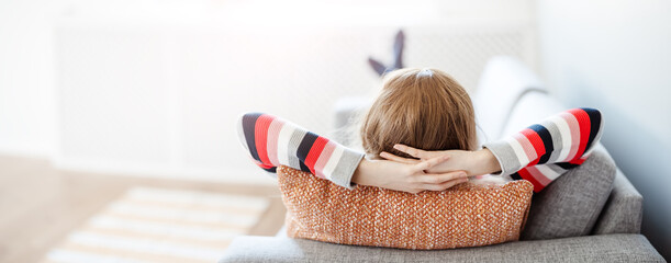 Tired woman lying down on the couch after workday.