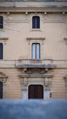 Facade of old shabby building with  balcony