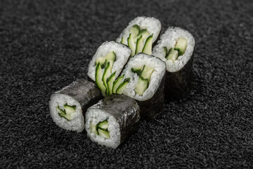 Sashi with cucumber, Asian cuisine. Photo of food on a dark background