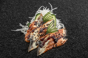 Sushimi eel, Asian cuisine. Photo of food on a dark background