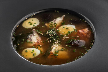 Soup with seaweed and egg, Asian cuisine. Photo of food on a dark background