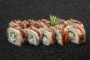 Sushi with cucumber, Asian cuisine. Photo of food on a dark background