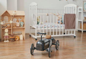 Children's room with car and crib. Toy house, toys in nursery. Playroom. Children's room interior