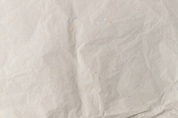 Packaging beige soft recycled paper texture with color inclusions as background