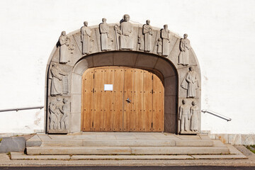 Vannas, Norrland Sweden - August 7, 2021: church gate with interesting stone figures in relief