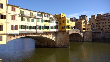 Fototapeta na wymiar Europe, Italy , Florence 2022 - Historic Ponte Vecchio bridge over the Arno River in Florence Italy near Cattedrale di Santa Maria del Fiore 