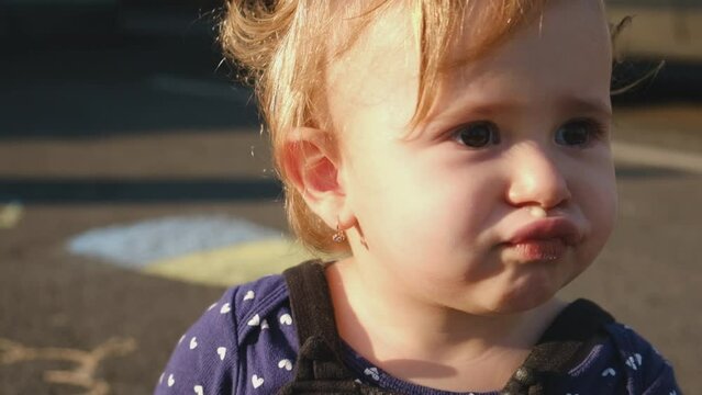 Baby has snot on her face. Selective focus.