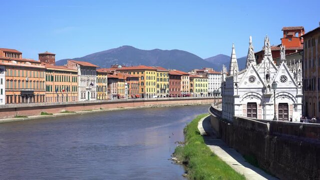 Italy, Europe, Pisa, April 2022  Arno river sunset from Solferino bridge. Lungarno view and Santa Maria della Spina small gothic church. Tuscany
