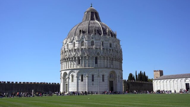 Europe, Italy , Pisa, Tuscany , April 2022 - Pisa Tower in Piazza dei Miracoli Duomo cathedral, marble statue and leaning Tower with tourists after finish of Covid-19 Coronavirus 