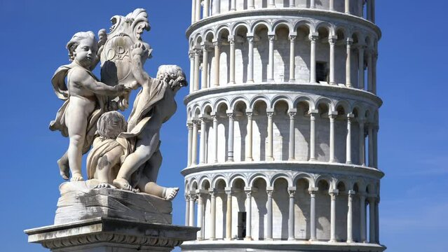 Europe, Italy , Pisa, Tuscany , April 2022 - Pisa Tower in Piazza dei Miracoli Duomo cathedral, marble statue and leaning Tower with tourists after finish of Covid-19 Coronavirus 