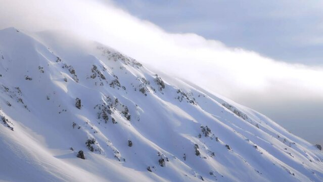 timelapse clouds rolling over winter mountain landscape - Italy