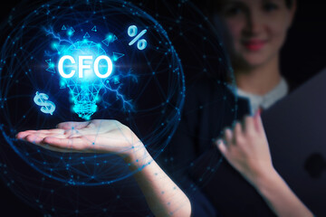 Business, Technology, Internet and network concept. Young businessman working on a virtual screen of the future and sees the inscription: CFO