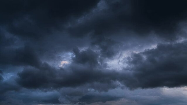 4K Timelapse view of a dark cloudy sky just before sunset - dramatic view