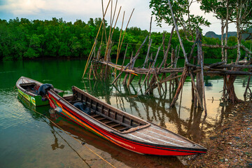Naklejka na ściany i meble The broken ship, an Old abandoned ship on the ocean shore.Thai wooden motorboat.