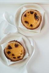Pastel de Nata, a traditional sweet from Portuguese cuisine. Small crunchy puff pastry pies and a cream made with eggs. Often tasted and accompanied with coffee. Top view