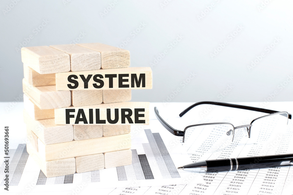 Poster system failure is written on wooden blocks on a chart background