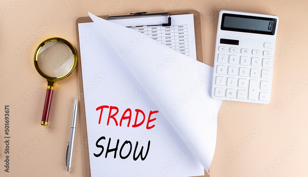 Poster clipboard with chart and text trade show with magnifier ,calculator on beige background